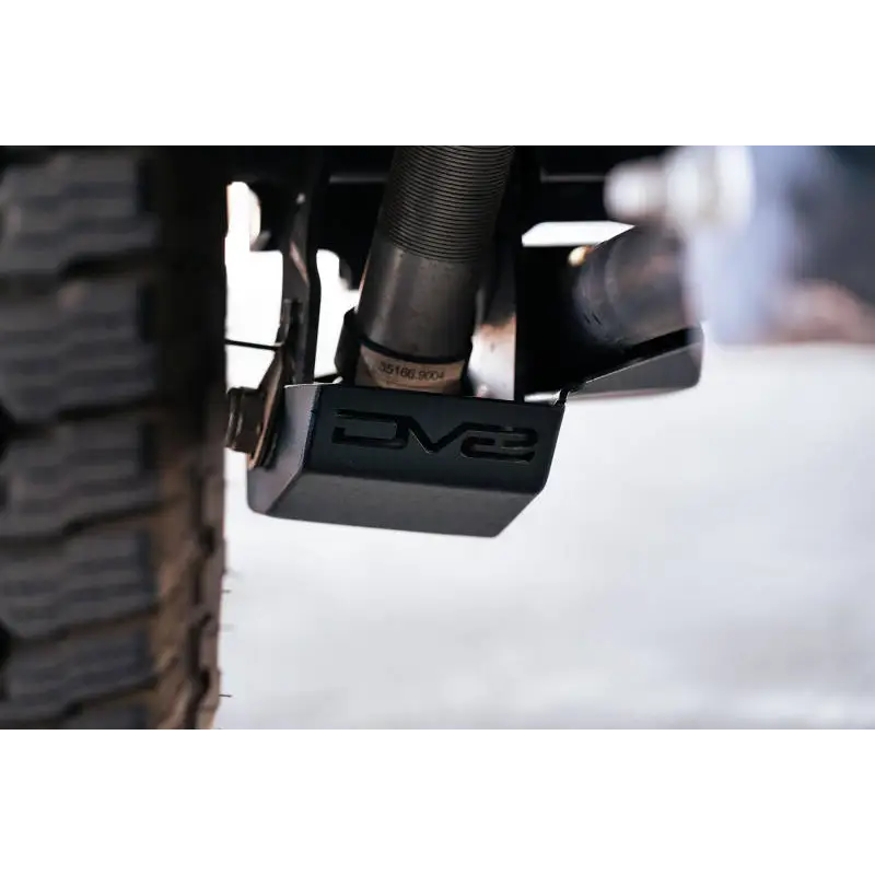 DV8 Offroad 2021-2022 Ford Bronco Rear Shock Guard Skid Plate showing front wheel mount on rear wheel.