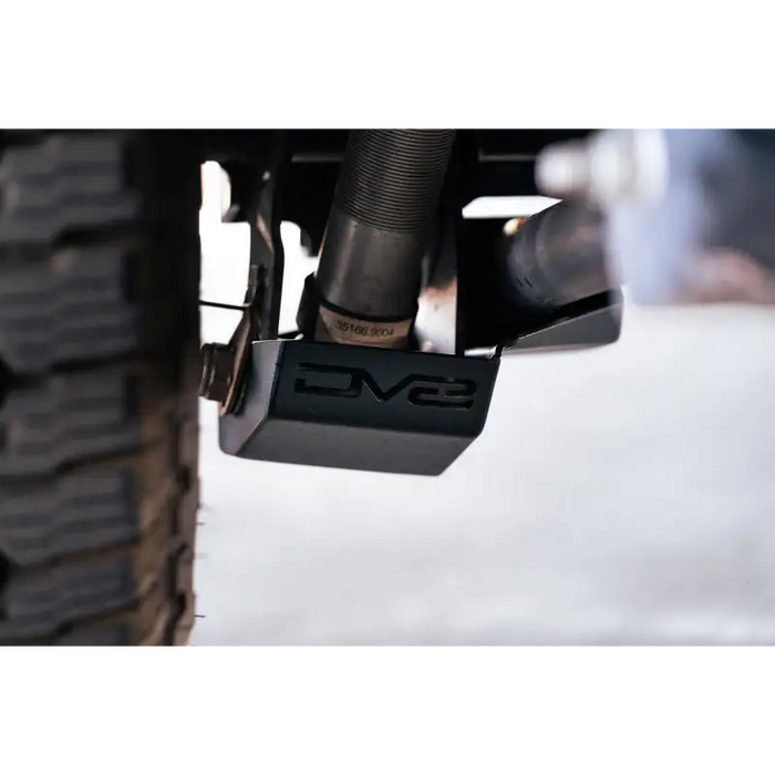 DV8 Offroad 2021-2022 Ford Bronco Rear Shock Guard Skid Plate showing front wheel mount on rear wheel.
