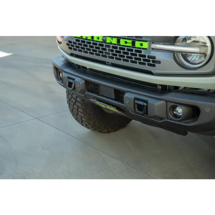 Green license plate mount on OEM Capable Steel Bumper.