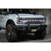 White truck with big bumper and license plate relocation bracket - DV8 Offroad Ford Bronco.
