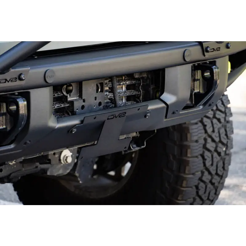 Close-up of truck with large bumper for DV8 Offroad 21-22 Ford Bronco License Plate Relocation Bracket.