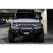 White truck parked with license plate relocation bracket in DV8 Offroad product.