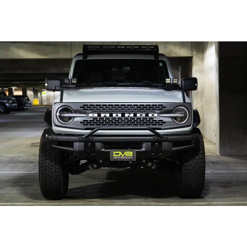 White truck parked with license plate relocation bracket in DV8 Offroad product.