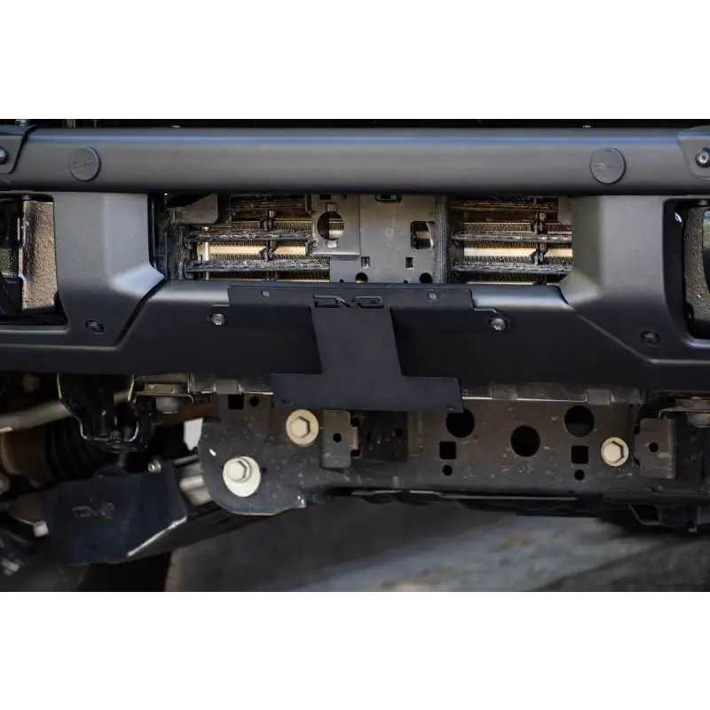 Close up of car bumper with license plate relocation bracket for Ford Bronco.