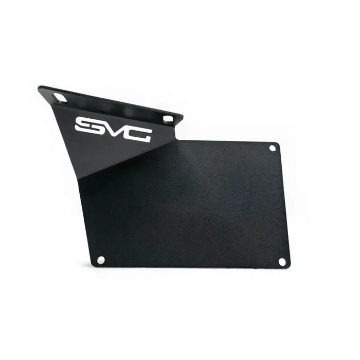 Black plate with white logo on DV8 Offroad relocation bracket for Jeep Wrangler.