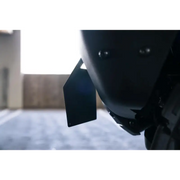 Close-up of motorcycle helmet with attached tag, DV8 Offroad license plate relocation bracket.