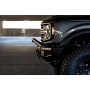 Black truck with light on DV8 Offroad Ford Bronco Factory Modular Front Bumper Bull Bar.
