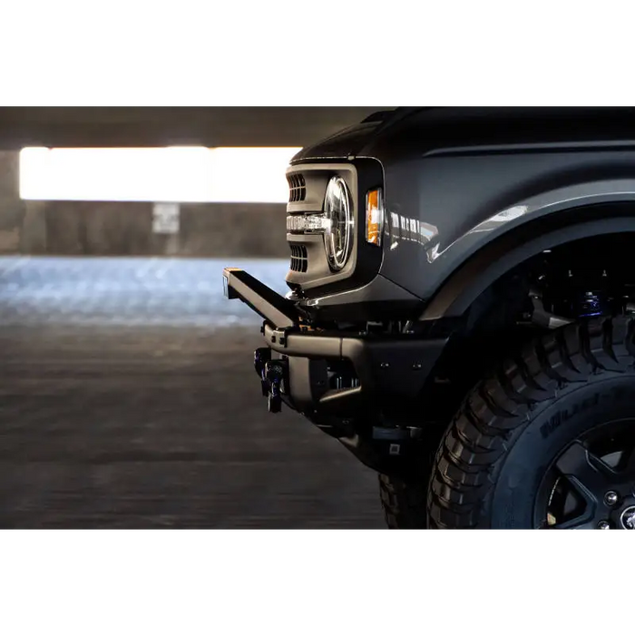 Black truck with light on DV8 Offroad Ford Bronco Factory Modular Front Bumper Bull Bar.