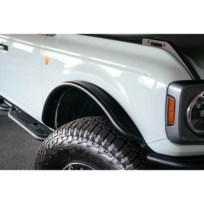 White truck with black bumper parked next to DV8 Offroad 21-22 Ford Bronco Front Inner Fender Liners