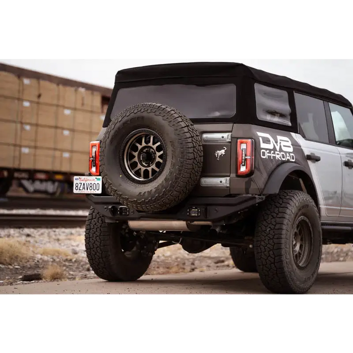 Black Jeep parked on road next to DV8 Offroad 21-22 Ford Bronco FS-15 Series Rear Bumper, made with 5mm steel.