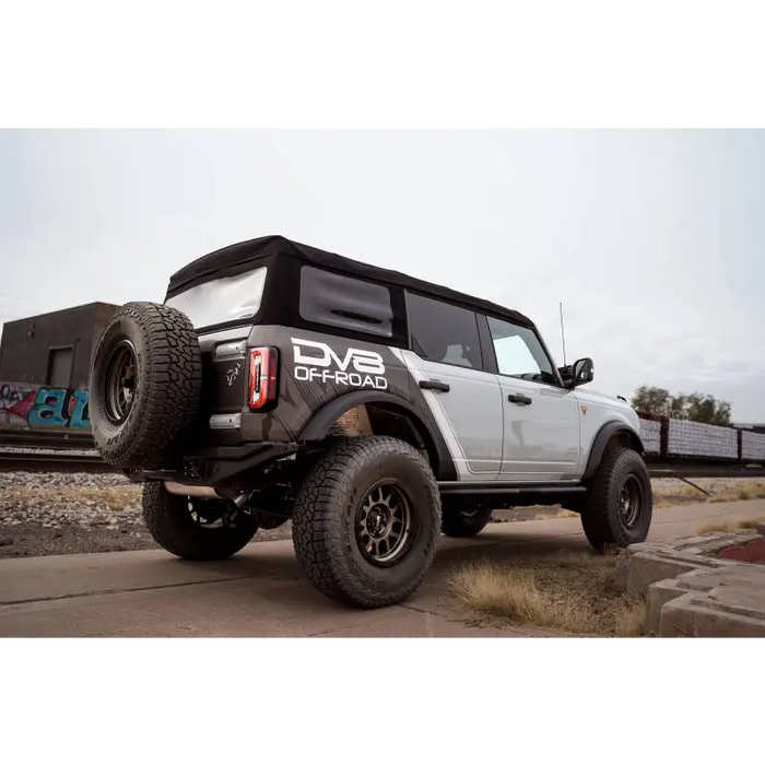 White truck with black tail light featuring DV8 Offroad 21-22 Ford Bronco FS-15 Series Rear Bumper.