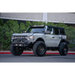 White truck with black roof rack on DV8 Offroad 21-22 Ford Bronco FS-15 Series Rock Sliders.