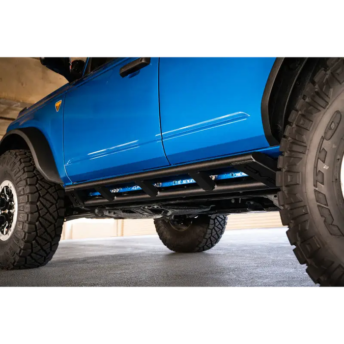 Blue lifted truck with large tire - DV8 Offroad FS-15 Series Rock Sliders
