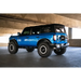 Blue truck parked in a parking garage with DV8 Offroad FS-15 Series Rock Sliders