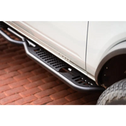 Close up of car tire on brick road - DV8 Offroad 21-22 Ford Bronco side steps