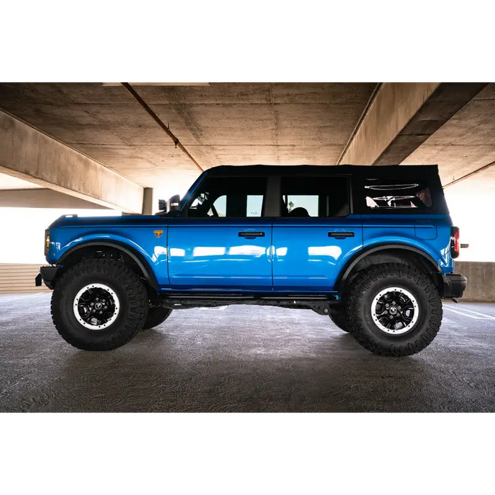 Blue lifted truck with big tire - DV8 Offroad Ford Bronco OE Plus Side Steps