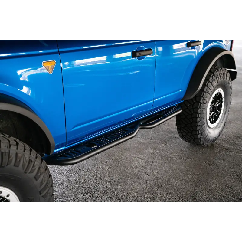 Blue truck with big tire - DV8 Offroad Ford Bronco OE Plus Series Side Steps.