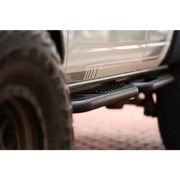 White truck rear bumper close-up DV8 Offroad Ford Bronco OE Plus Series Side Steps.