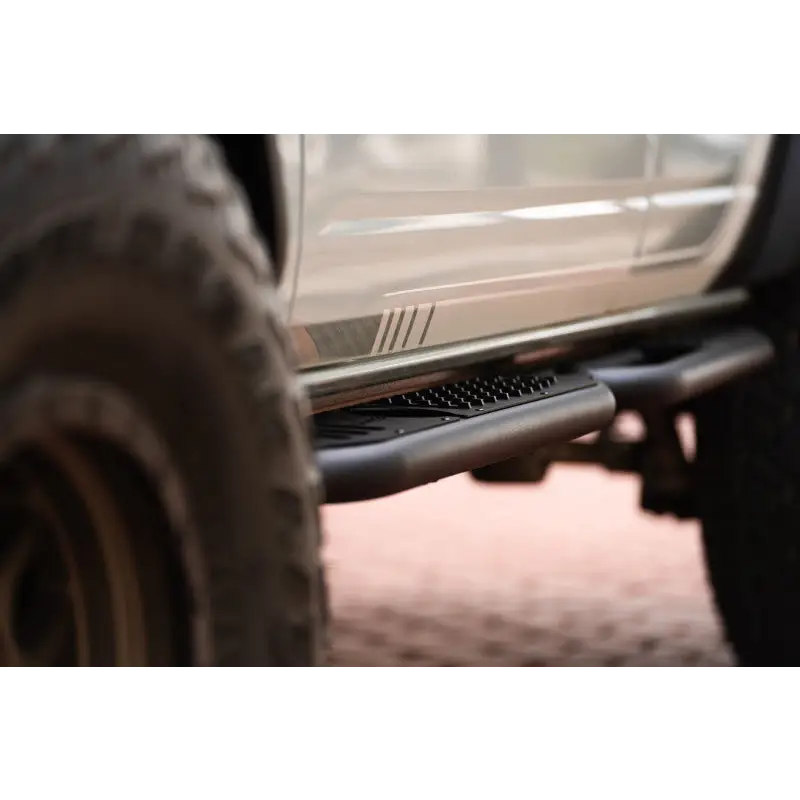 White truck rear bumper close-up DV8 Offroad Ford Bronco OE Plus Series Side Steps.