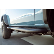 Close up of DV8 Offroad 21-23 Ford Bronco 2-Door Pinch Weld Covers on a truck with bumper.