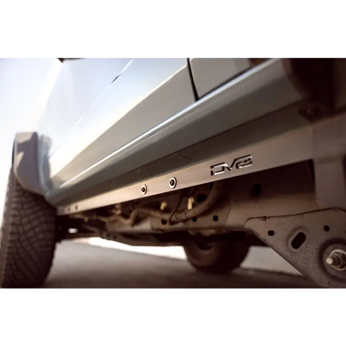 DV8 Offroad 21-23 Ford Bronco 2-Door Pinch Weld Covers featuring a car with a flat tire