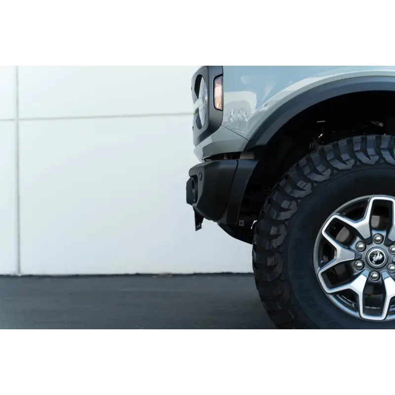 DV8 Offroad 21-23 Ford Bronco front license plate mount with tire on truck