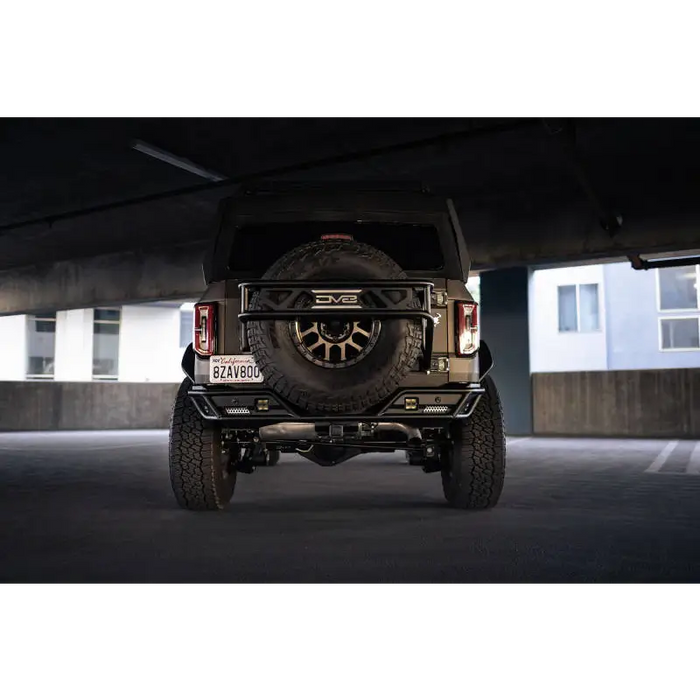 Black Jeep with large tire - DV8 Offroad Bronco Competition Series Rear Bumper