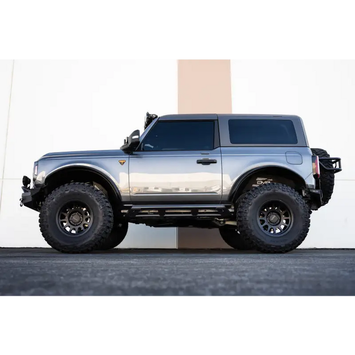 Silver truck parked in front of building - DV8 Offroad Ford Bronco Rock Sliders