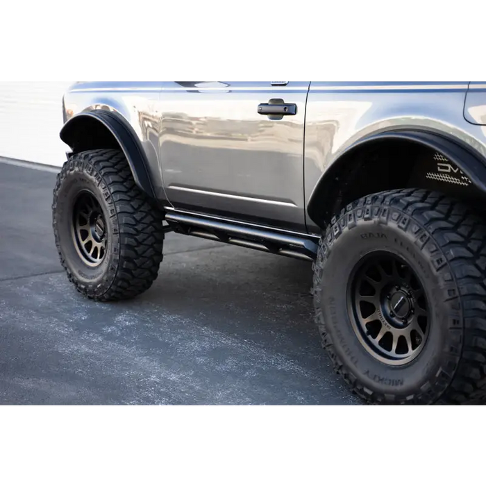Silver truck with black tire - DV8 Offroad Ford Bronco rock sliders