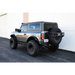 Offroad black Jeep parked in front of building beside DV8 rock sliders for Ford Bronco.