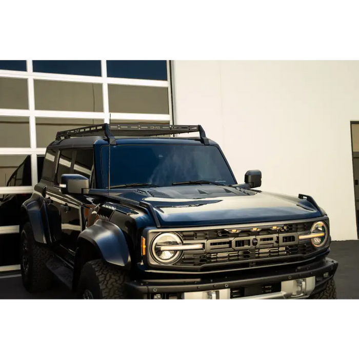 Black truck parked in front of building, DV8 Offroad 21-23 Ford Bronco Hard Top Roof Rack.