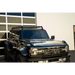 Black truck parked in front of building, DV8 Offroad 21-23 Ford Bronco Hard Top Roof Rack.