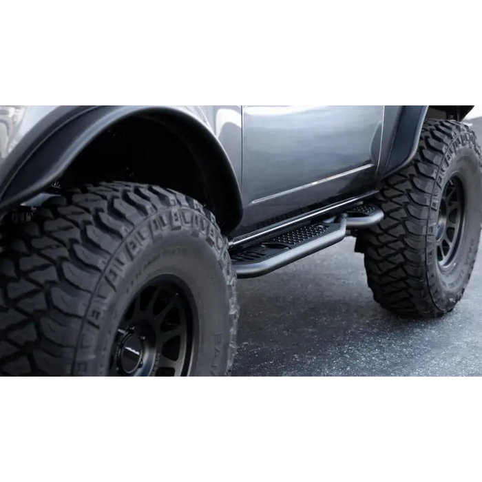 Black truck with large tire - DV8 Offroad 21-23 Ford Bronco OE Plus 2-Door Side Steps