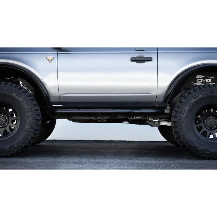 Silver Ford Bronco with black tire from DV8 Offroad OE Plus Side Steps.