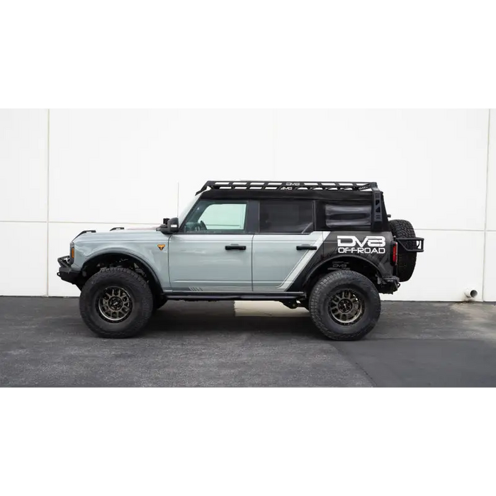 Gray Jeep parked in front of white wall with DV8 Offroad 21-23 Ford Bronco Pinch Weld Covers.