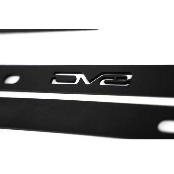 Close up of black and white car emblems on DV8 Offroad Ford Bronco Pinch Weld Covers