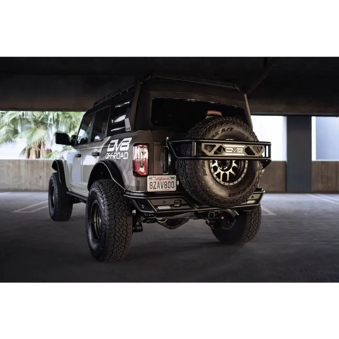 Jeep with tire rack parked near DV8 Offroad Bronco Rear License Plate Relocation Bracket