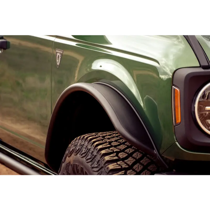 Green truck with black bumper and tire - DV8 Offroad Ford Bronco fender flares