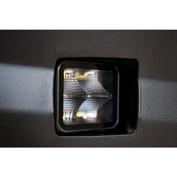 DV8 Offroad 3in Cube Elite Series Lights - close up of pod light on wall