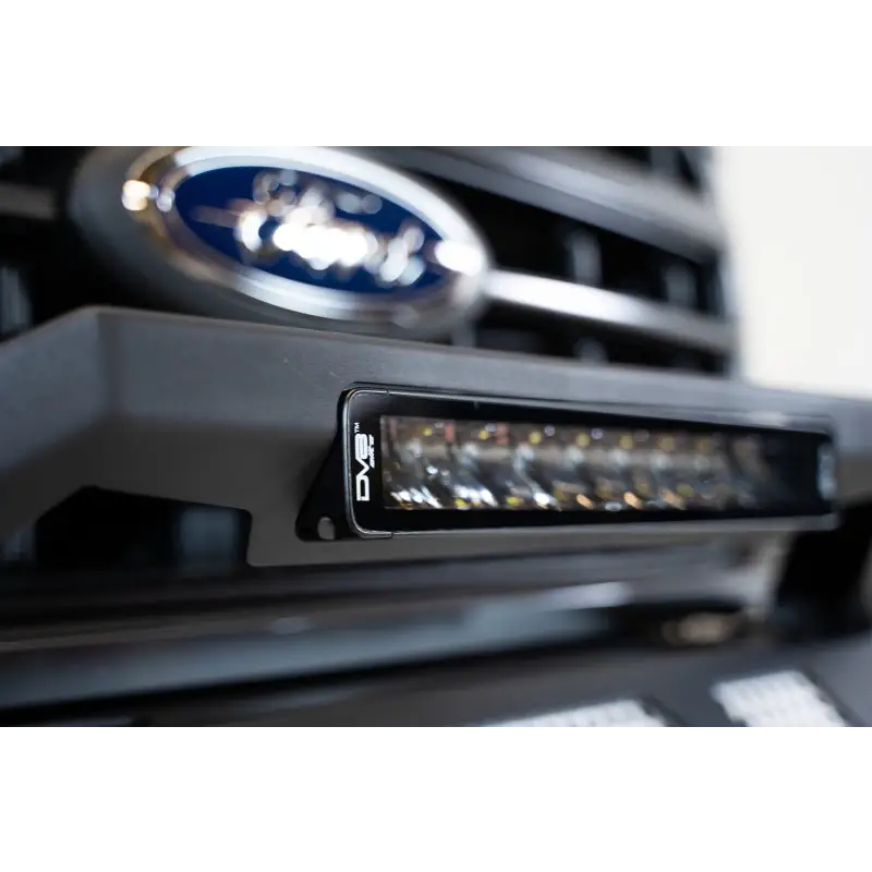 Close up of Ford logo on car grille in DV8 Offroad Elite Series 13in Light Bar.