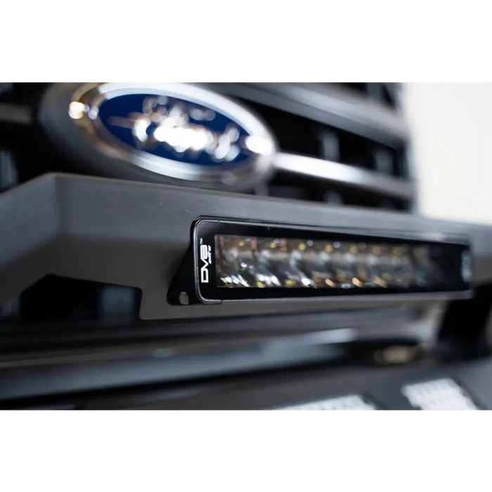 Close up of Ford logo on car grille in DV8 Offroad Elite Series 13in Light Bar.