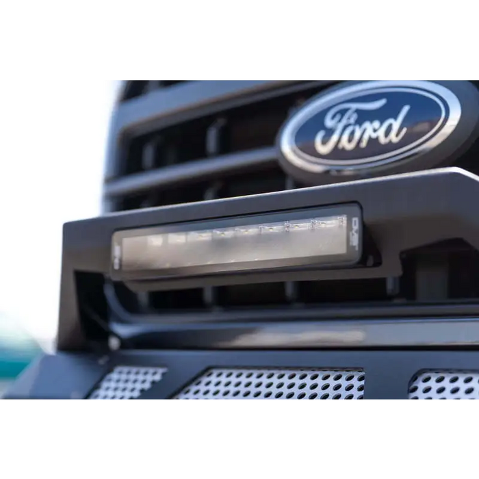 Close up of a Ford logo on DV8 Offroad Elite Series 13in Light Bar 45W Flood/Spot LED truck grille