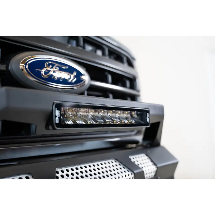 Close up of Ford vehicle grille with DV8 Offroad Elite Series 13in Light Bar 45W Flood/Spot LED