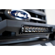 Close up of car grille with Ford logo on DV8 Offroad Elite Series 13in Light Bar 45W Flood/Spot LED.