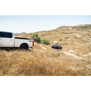 White truck parked in grass near DV8 Offroad Elite Series D-Ring Shackles (Black)
