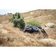 Black DV8 Offroad Elite Series D-Ring Shackles stuck in grass