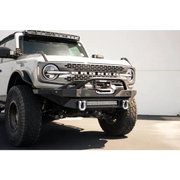 Gray DV8 Offroad Elite Series D-Ring Shackles in a parking lot