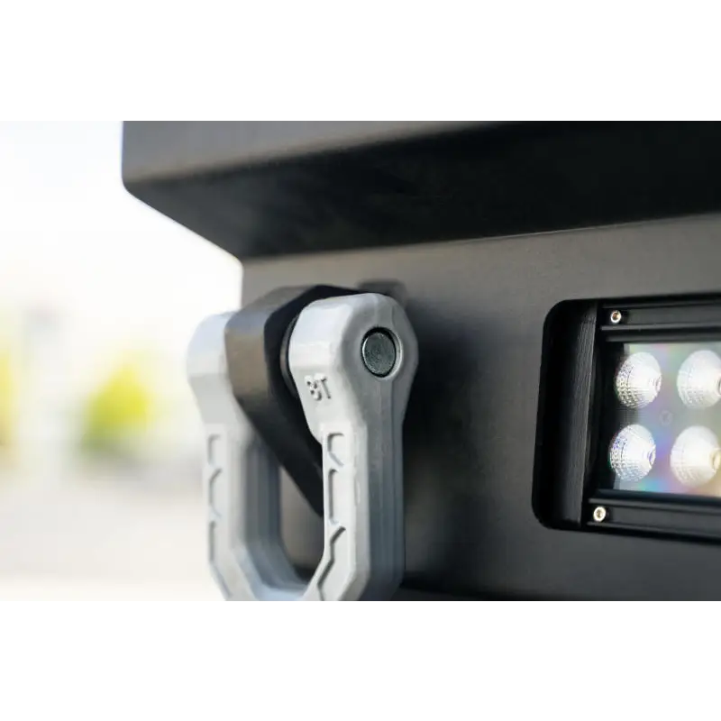 DV8 Offroad Elite Series D-Ring Shackles mounted on vehicle side.