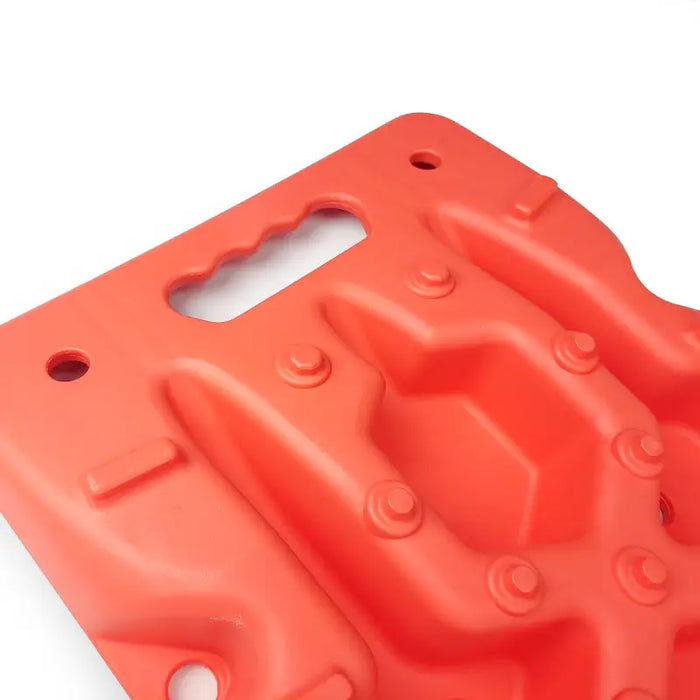 Red plastic water bottle with a hole on DV8 Offroad Recovery Traction Boards.