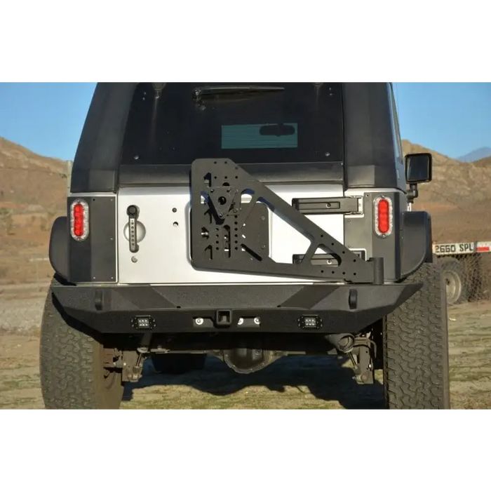 Black Jeep with License Plate on Bumper Mounted Tire Carrier DV8 Offroad RS-10/RS-11 TC-6